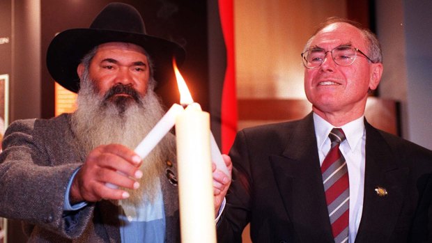 Chairman of the Council for Aboriginal Reconciliation Pat Dodson lights a candle with former prime minster Howard at a luncheon in the Great Hall of Parliament House to mark the start of Reconciliation week.