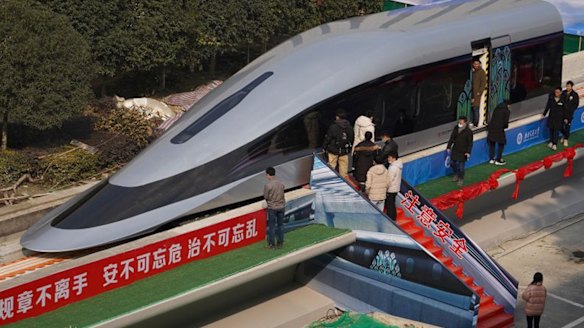 People visit a prototype magnetic levitation train developed with high-temperature superconducting (HTS) maglev technology during the launch ceremony in Chengdu.