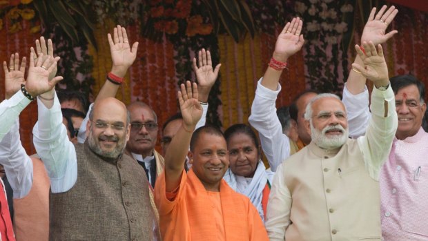 Yogi Adityanath, centre in saffron robes, with Indian Prime Minister Narendra Modi, second from right, after Adityanath's swearing-in in Lucknow on March 19.