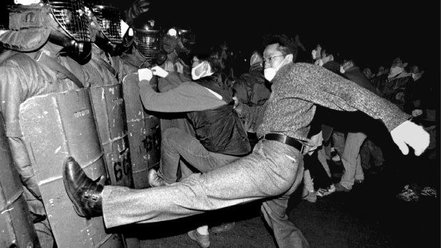 Students attack riot police who block their march  to former president Chun Doo-hwan's house in Seoul, in December 1995.  About 1,500 students demanded punishment for Chun, who was president at the time of the 1980 Kwangju military massacre. 
