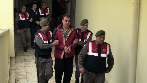 Turkish paramilitary police officers escort Syrian smugglers Muwafaka Alabash, front, and Asem Alfrhad, rear. for their trial in Bodrum, Turkey, on Friday. 