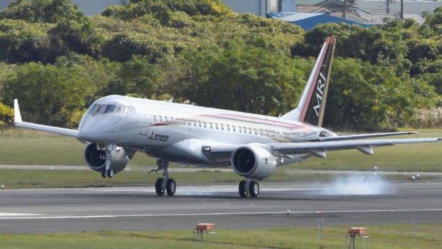 The Mitsubishi Regional Jet (MRJ), lands at Nagoya Airport in Toyoyama, after completing its first flight.