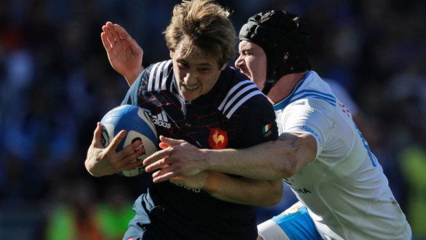 France's Baptiste Serin is chased down by Italy's Carlo Canna during their Six Nations clash in Rome on Saturday.