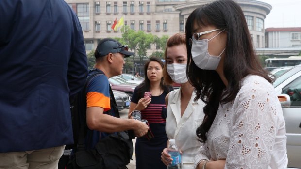 Employees and families of Crown Resort arrive at Baoshan People's Court on Monday morning. 