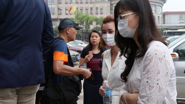 Employees and families of Crown Resort arrive at Baoshan People's Court on Monday morning. 