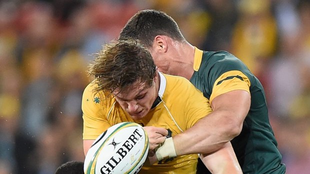 Spilled pill: Michael Hooper of the Wallabies loses the ball in a tackle. 