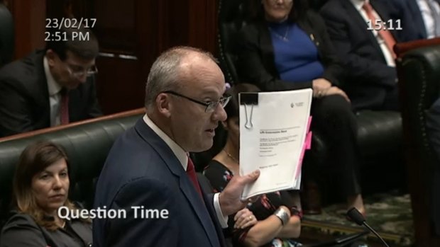 NSW Opposition leader Luke Foley holding a leaked copy of the LPI concession deed during Question Time in February.
