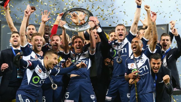 Melbourne Victory, and coach Kevin Muscat, celebrate winning the A-League championship after their grand final triumph over Sydney FC.