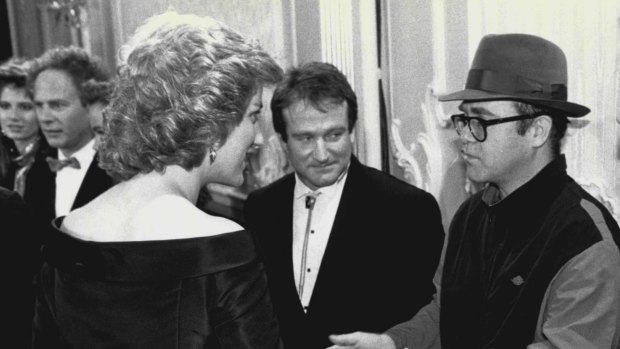 Princess Diana meets one of her favourite performers Elton John (with Robin Williams looking on).