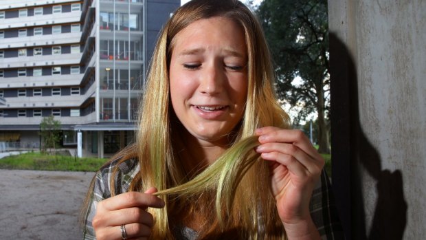 Desperate measures: Melissa Brueckner inspects her damaged hair.