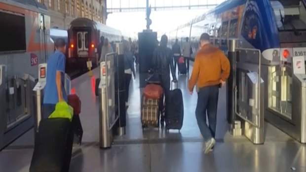 This image taken from video shows passengers inside Marseille-Saint-Charles railway station in Marseille, France.