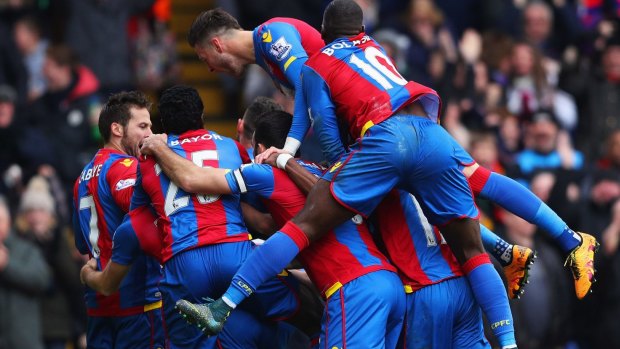 Joe Ledley is mobbed by Palace teammates after scoring against Liverpool.
