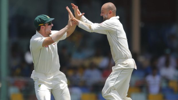 Mistimed sweep: Nathan Lyon celebrates the wicket of Angelo Mathews off an ill-judged shot with Mitchell Marsh.