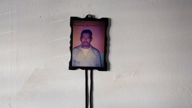 A photograph of the 15-year-old boy's father, who was killed by a gang.