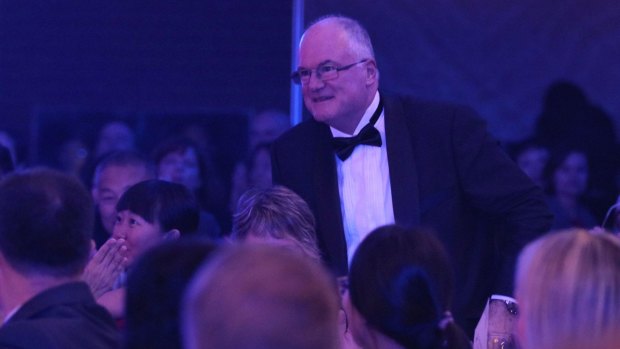 Professor Craig
Anderson, a founder and principal director of The George Institute for Global Health, walks up to receive the social responsibility award.