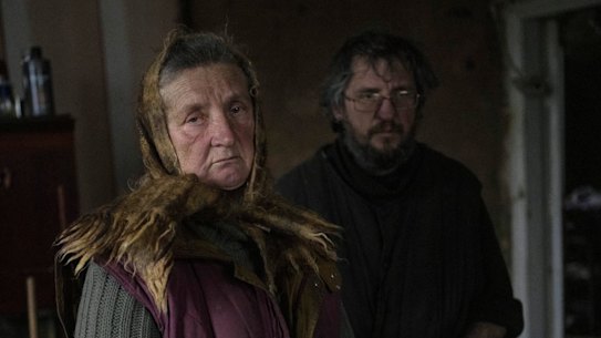 Nadiya Trubchaninova, 70, poses for the picture with her son Oleg Trubchaninov, 46, inside the room of her son Vadym, 48, who was killed by Russian soldiers last March 30 in Bucha, in the outskirts of Kyiv, Ukraine, Wednesday, April 13, 2022. (AP Photo/Rodrigo Abd)