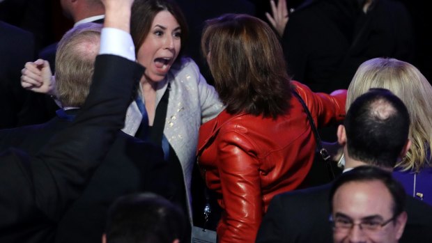 Supporters of Donald Trump celebrate as they watch the election results.