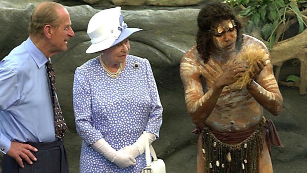 Prince Philip and the Queen in Cairns in 2002 watch as Warren Clements of the Tjapakai dance group makes fire.