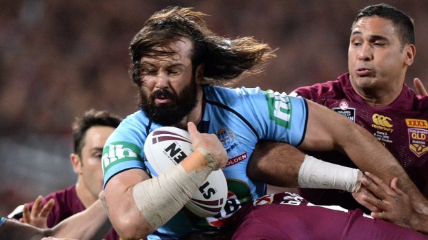 Aaron Woods of the Blues is tackled during game three of the State of Origin.