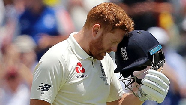 Keeping it light: Bairstow celebrates his ton with a mock headbutt of his helmet.