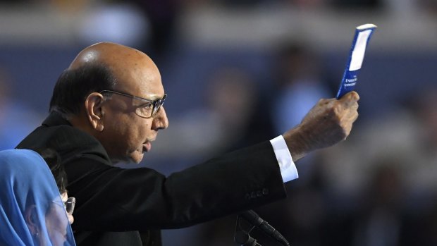 Khizr Khan, father of fallen US Army Captain, holds up his copy the United State Constitution as he speaks during the final day.