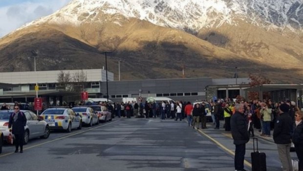 Passengers outside Queenstown Airport after a bomb scare. 