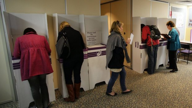 Canberrans, pictured voting in Civic in 2010, are more used to overseas travel than voting in July. 