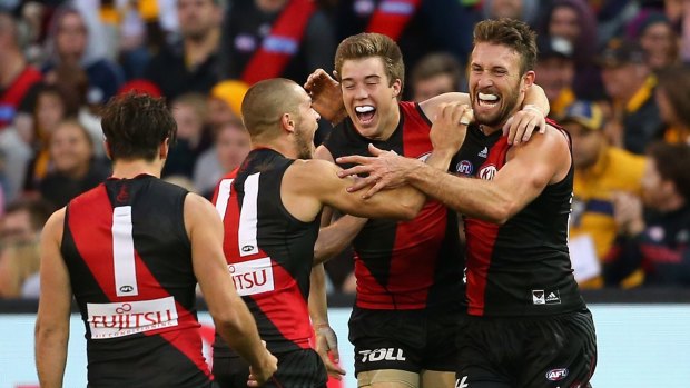 Cale Hooker is congratulated by teammates after kicking a goal late in the game against Hawthorn.