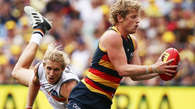 Evasive: Rory Sloane slips a tackle to set up another Crows attack.