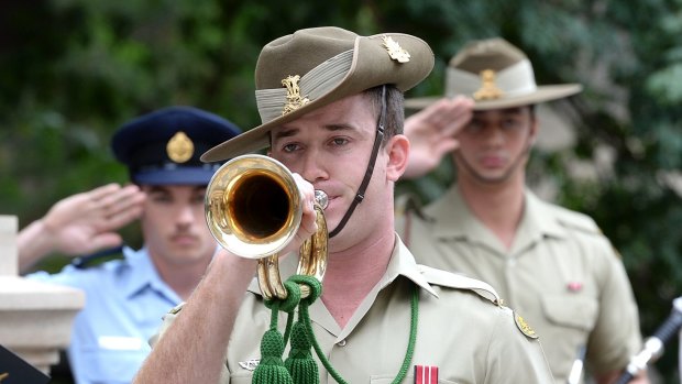 A soldier plays the last post at Queensland's largest Rememberance Day service at the ANZAC square on November 11, 2015 in Brisbane.