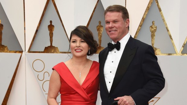 Martha L. Ruiz and Brian Cullinan from PricewaterhouseCoopers arrive at the Oscars.