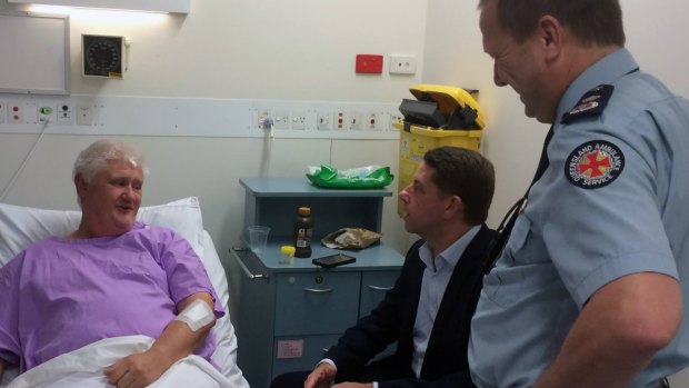 Ambulance Services Minister Cameron Dick and Queensland Ambulance Service Commissioner Russell Bowles visit the injured Fraser Island paramedic in hospital on Saturday.