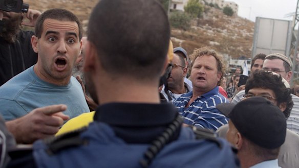 Israeli settlers scuffle with policemen during a demonstration in the occupied West Bank at the Palestinian village of Beit Sahur.