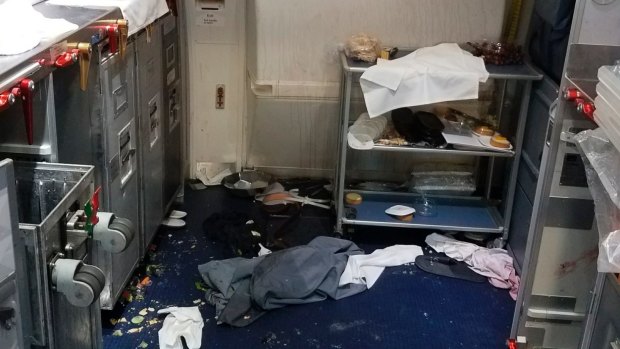 A photo taken by the FBI shows the aftermath of a cabin on Delta Flight 129 from Seattle to Beijing.