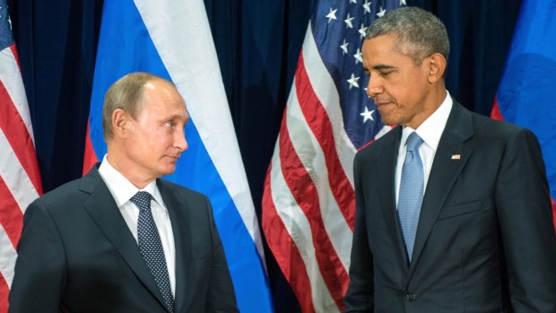 US President Barack Obama and Russia's President Vladimir Putin pose for photos before a bilateral meeting on Monday.