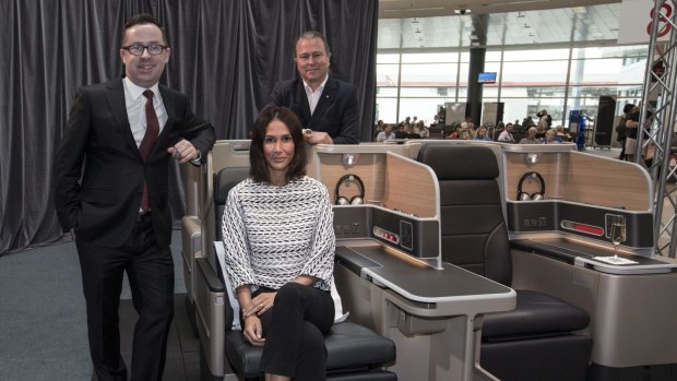 Qantas ambassador Lindy Klim models the new A330 Business Suite, accompanied by CEO Alan Joyce (left) and chef Neil Perry.
