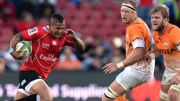 Full charge: Elton Jantjies of the Lions runs through a gap.