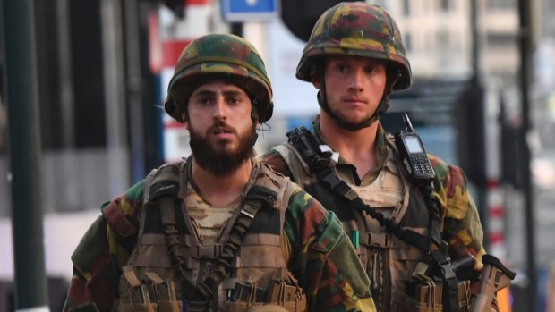 Belgian Army soldiers patrol outside Central Station after a man was shot dead by troops.
