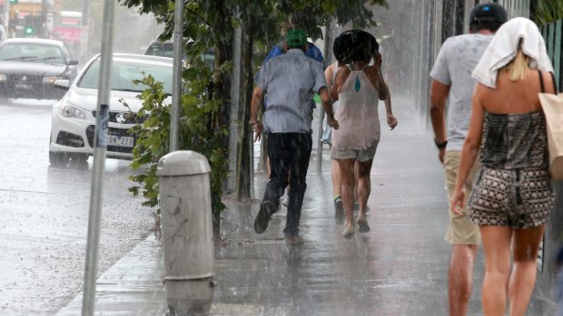 Heavy rain catches people by surprise in St Kilda.
