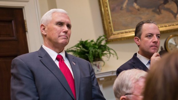 Vice-President Mike Pence, left, and White House Chief of Staff Reince Priebus listen as President Donald Trump speaks.
