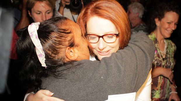 Prime Minister Julia Gillard is hugged after she offered the National Apology for Forced Adoptions in the Great Hall at Parliament House in Canberra.