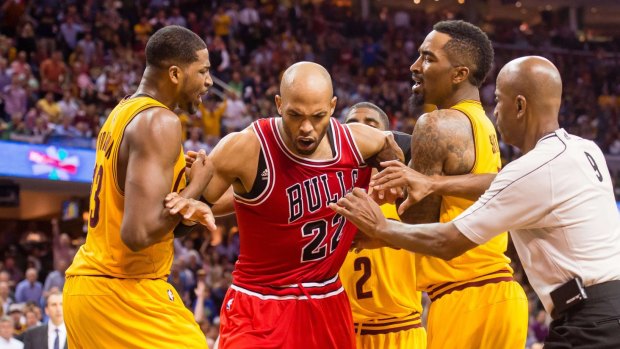 Playoff inficident: Taj Gibson is held back after clashing with Matthew Dellavedova.