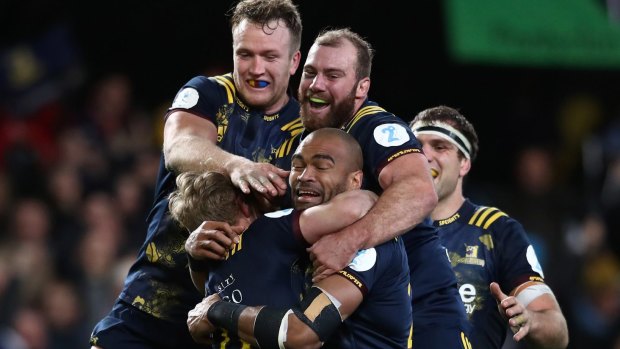 Historic win: Highlanders players celebrate their team's 23-22 victory over the British & Irish Lions in Dunedin.