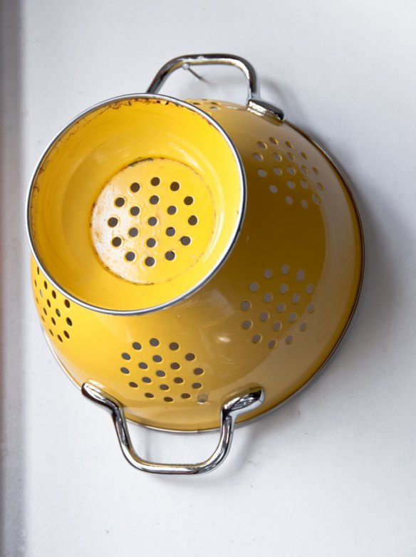 Awkward items such as colanders can be hung from hooks in the cupboard under the sink.
