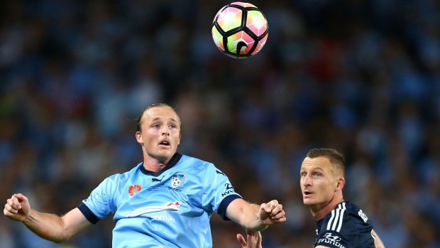 Rhyan Grant of Sydney FC and Besart Berisha of the Victory contest possession.
