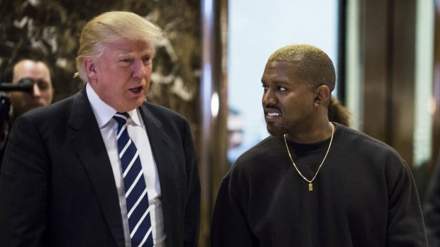 US President Donald Trump and Kanye West in the lobby of Trump Tower, New York, in December.