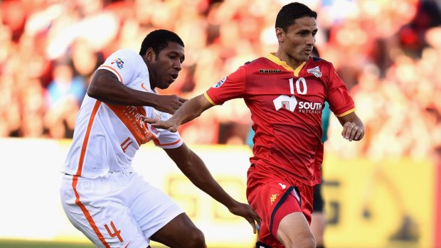 Adelaide's Marcelo Carrusca competes with Jucilei da Silva of Shandong Luneng during the AFC Champions League play-off match.