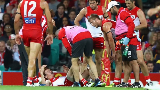 Ouch: Gary Rohan reacts after injuring his knee.