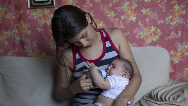 A woman feeds her daughter Luiza, who was born with microcephaly in Santa Cruz do Capibaribe, Brazil.