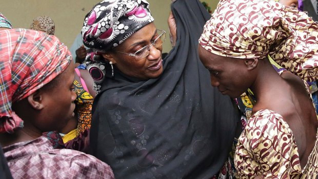 In an earlier incident in October, one of the released girls freed from Boko Haram is met by a Nigerian government official in Abuja.